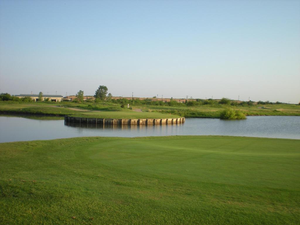 green surrounded by water at Thunder Bayou Golf Links